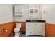 Well-lit bathroom featuring paneled walls, a modern vanity, and ample storage space at 300 Carol Ann Dr, Edgewater, FL 32132