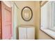 This bathroom features a vanity with storage, an oval mirror, and a window for natural light at 300 Carol Ann Dr, Edgewater, FL 32132
