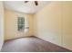 Empty bedroom with carpeted floors, ceiling fan and natural light at 300 Carol Ann Dr, Edgewater, FL 32132