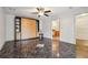 Bedroom with dark marble floors, ceiling fan, Murphy bed, and an ensuite bath at 300 Carol Ann Dr, Edgewater, FL 32132