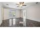 Spacious bedroom featuring a ceiling fan, double doors to the outside, and beautiful tile floors at 300 Carol Ann Dr, Edgewater, FL 32132