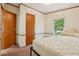 Bedroom features a large window, closets and a bed frame at 300 Carol Ann Dr, Edgewater, FL 32132