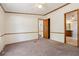Spacious bedroom with neutral carpet, light walls and multiple entry doors at 300 Carol Ann Dr, Edgewater, FL 32132