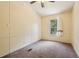 Empty bedroom features carpeted floors, ceiling fan and bright window at 300 Carol Ann Dr, Edgewater, FL 32132