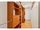 Organized walk-in closet with wooden shelves and drawers for efficient storage solutions at 300 Carol Ann Dr, Edgewater, FL 32132