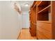Walk-in closet with wooden shelving and drawers for organized storage and easy access to clothing at 300 Carol Ann Dr, Edgewater, FL 32132