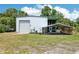 Exterior of metal home with a garage and covered parking area at 300 Carol Ann Dr, Edgewater, FL 32132