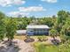 Single-story home with screened-in porch and fire pit area at 300 Carol Ann Dr, Edgewater, FL 32132