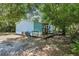 Light blue home with a wooden deck surrounded by trees and greenery at 300 Carol Ann Dr, Edgewater, FL 32132