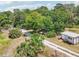 View of property with gravel driveway and detached garage at 300 Carol Ann Dr, Edgewater, FL 32132