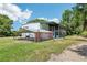 Spacious home with an attached awning, open carport and a large screened-in outdoor living space at 300 Carol Ann Dr, Edgewater, FL 32132