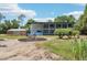 Exterior shot of metal home with fire pit area at 300 Carol Ann Dr, Edgewater, FL 32132