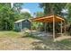 Exterior shot of wooden shed with covered parking area at 300 Carol Ann Dr, Edgewater, FL 32132