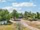Exterior of a single-story home and detached garage surrounded by trees at 300 Carol Ann Dr, Edgewater, FL 32132