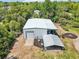 Metal building with garage, carport, and adjacent landscaping at 300 Carol Ann Dr, Edgewater, FL 32132
