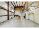 Expansive garage with high ceilings, steel beams, and concrete flooring provides versatility at 300 Carol Ann Dr, Edgewater, FL 32132