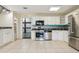 Bright kitchen featuring stainless steel appliances, white cabinets, and lots of storage space at 300 Carol Ann Dr, Edgewater, FL 32132