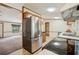 A view of the kitchen with stainless steel appliances and sight lines to the living room at 300 Carol Ann Dr, Edgewater, FL 32132