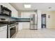 Bright kitchen featuring stainless steel appliances, white cabinets, and lots of storage space at 300 Carol Ann Dr, Edgewater, FL 32132