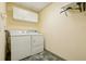 Functional laundry room with washer, dryer, and overhead cabinets for storage at 300 Carol Ann Dr, Edgewater, FL 32132