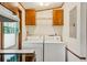 A view of the laundry area with washer and dryer, and overhead cabinets at 300 Carol Ann Dr, Edgewater, FL 32132