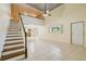 Open concept living room featuring tile flooring, high ceilings, staircase and lots of light at 300 Carol Ann Dr, Edgewater, FL 32132