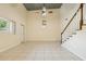 Open living room with tile flooring, high ceilings, and a staircase to the second floor at 300 Carol Ann Dr, Edgewater, FL 32132