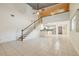 Spacious living room with tile floors, high ceilings, and a staircase leading to the upper level at 300 Carol Ann Dr, Edgewater, FL 32132