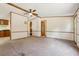 Spacious living room with neutral carpeting and ceiling fan, adjacent to the kitchen at 300 Carol Ann Dr, Edgewater, FL 32132