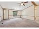 Bright living room featuring a ceiling fan and neutral carpeting, with a window offering natural light at 300 Carol Ann Dr, Edgewater, FL 32132