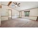 Inviting living room with a ceiling fan and neutral carpeting, illuminated by a bright window at 300 Carol Ann Dr, Edgewater, FL 32132
