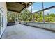 Large screened-in patio with ceiling fan, hot tub, and view of tropical landscaping at 300 Carol Ann Dr, Edgewater, FL 32132
