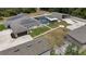 Aerial view showcasing the home, pool, outbuildings, solar panels, and spacious landscaping of the expansive property at 3055 Wolf Branch Rd, Mount Dora, FL 32757