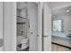 Bathroom with bathtub, toilet, and open view of the bedroom at 3055 Wolf Branch Rd, Mount Dora, FL 32757
