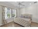 Comfortable bedroom featuring a tufted headboard, light wood flooring, and natural light at 3055 Wolf Branch Rd, Mount Dora, FL 32757
