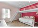 Fun bedroom design with a loft bed, plush bedding, hardwood floors, and bright, complementary paint scheme at 3055 Wolf Branch Rd, Mount Dora, FL 32757