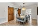 Dining room with sliding barn doors and a modern chandelier at 3055 Wolf Branch Rd, Mount Dora, FL 32757