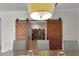 Open dining room featuring modern barn doors, chairs and chandelier at 3055 Wolf Branch Rd, Mount Dora, FL 32757