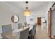 Dining room with a glass-top table, stylish chairs, and a view into the living area at 3055 Wolf Branch Rd, Mount Dora, FL 32757