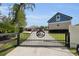 Long driveway leading to a home with a decorative gate and mature landscaping at 3055 Wolf Branch Rd, Mount Dora, FL 32757