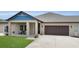 Charming exterior with a covered porch, neat landscaping, and an attached garage at 3055 Wolf Branch Rd, Mount Dora, FL 32757