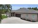 Elegant home with a paved driveway and a spacious three-car attached garage at 3055 Wolf Branch Rd, Mount Dora, FL 32757