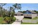Stunning exterior with a long driveway, beautiful landscaping, and ample parking space at 3055 Wolf Branch Rd, Mount Dora, FL 32757