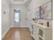 Bright foyer featuring wood-look tile floors, white trim and gray front door at 3055 Wolf Branch Rd, Mount Dora, FL 32757