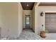 Inviting front entrance with a blue door, stone flooring, a stylish light fixture, and a view of the garage door at 3055 Wolf Branch Rd, Mount Dora, FL 32757
