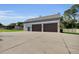 Custom garage with ample parking, a side entrance, and an extended concrete driveway at 3055 Wolf Branch Rd, Mount Dora, FL 32757