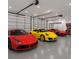 Finished three car garage with sleek epoxy floors and overhead lighting and modern garage doors at 3055 Wolf Branch Rd, Mount Dora, FL 32757