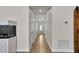 Inviting hallway with wood-look tile flooring and a decorative aquarium at 3055 Wolf Branch Rd, Mount Dora, FL 32757