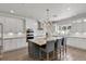 Elegant kitchen with a large island, chandelier, and stainless steel appliances at 3055 Wolf Branch Rd, Mount Dora, FL 32757
