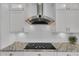 Modern kitchen with a stainless steel range hood and a flat cooktop at 3055 Wolf Branch Rd, Mount Dora, FL 32757